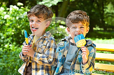 Identical twins with lollipops Stock Photo