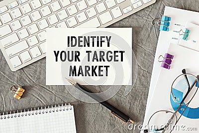 Identify Your Target Market is written in a document on the office desk Stock Photo