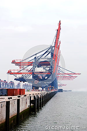 Idle harbor cranes on a misty Stock Photo