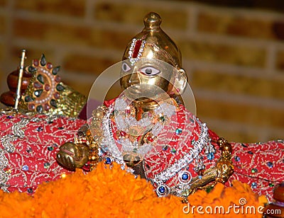 Idol of cute Baby Krishna with silk clothes and ornaments Stock Photo