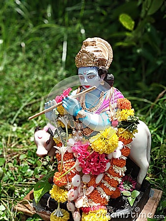 Idol of Lord Krishna playing his basaree Editorial Stock Photo