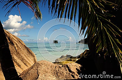 Tropical beach with granitic rocks and blue water Stock Photo