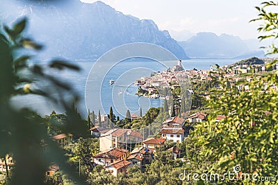 Idyllic coastline scenery in Italy: Blue water and a cute village at lago di garda, Malcesine Stock Photo