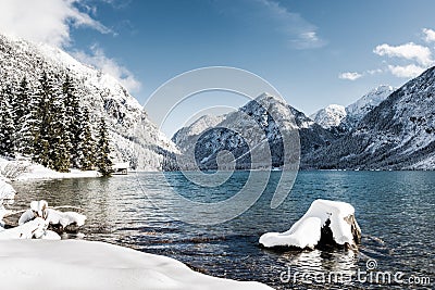 Idyllic cold lake at snow mountain landscape Stock Photo