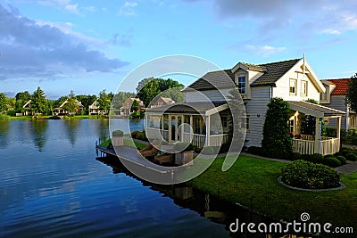 Idyllic holiday homes lakeside by sunrise Stock Photo