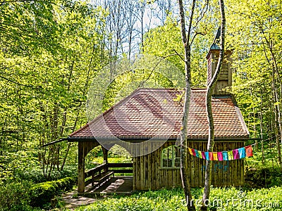 A idyllic house in the green woodland, idyllic architecture of wooden raw material. Stock Photo