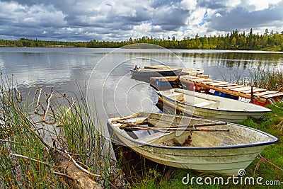 Idyllic lake scenery with boats in cloudy day Stock Photo