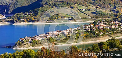 Idyllic lake scenery - Lago Turano and beautiful village Cole di Tora in Rieti province, Italy Stock Photo