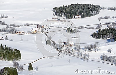 Lovely rural countryside on snowy winter day. Aerial view of barnyards and farm. Weitnau, Allgau, Bavaria, Germany. Stock Photo