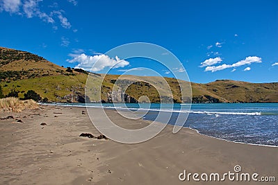 Idyllic sand beach on Akaroa peninsula in New Zealand Stock Photo