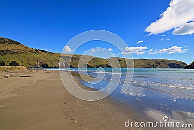 Idyllic sand beach on Akaroa peninsula in New Zealand Stock Photo