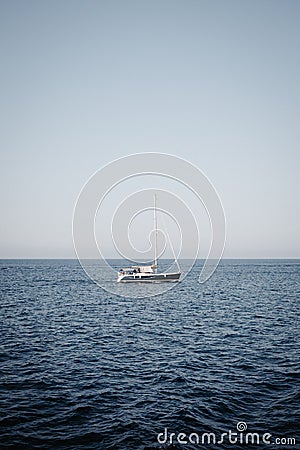 Idyllic scene of a sailboat gliding across the open ocean Stock Photo