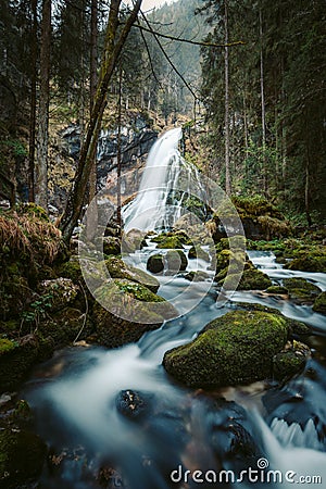 Idyllic waterfall scene with mossy rocks in the forest Stock Photo