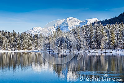 Idyllic winter wonderland with mountain lake in the Alps Stock Photo