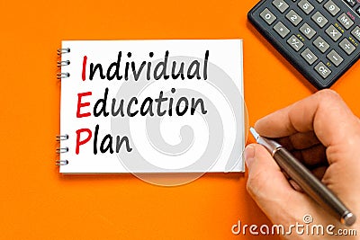 IEP individual education plan symbol. Concept words IEP individual education plan on white note on a beautiful orange background. Stock Photo