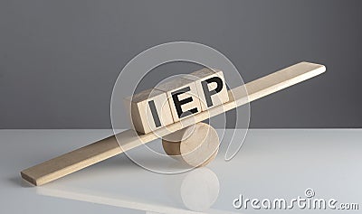 IEP on wooden cubes on a wooden balance , business concept Stock Photo