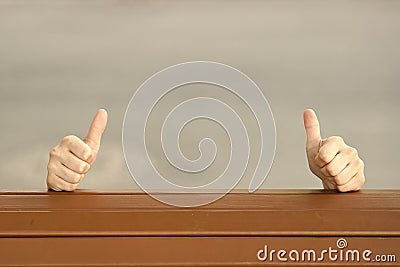 If you like it thumbs ups. Human hands giving thumbs ups sign on grey background. Extending hands with thumbs ups Stock Photo