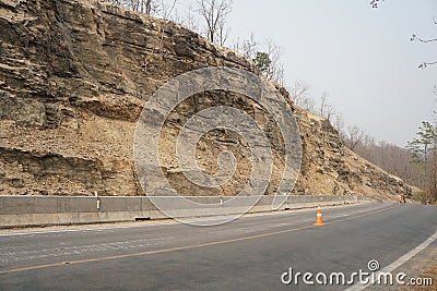 The asphalt road in Doi Inthanon National Park is a geological structure consisting of gneiss metamorphic rocks and igneous rocks. Stock Photo