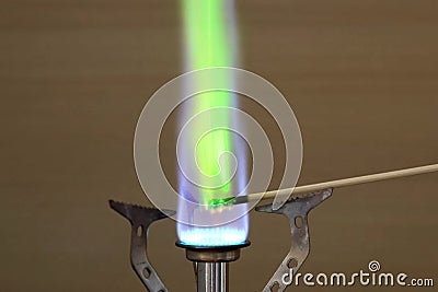 Ignition of copper oxide on a mini burner with stick. on the mini burner. Chemical experiments Stock Photo