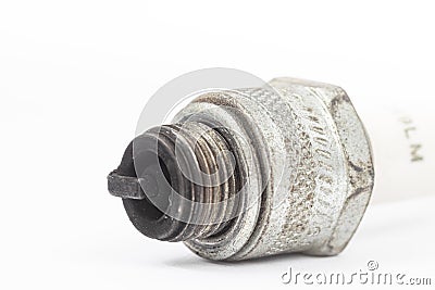 Ignition spark plug with platinum electrode. Automotive parts isolated above white background Stock Photo