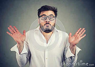Ignorant man shrugging with shoulders Stock Photo