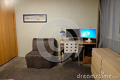 IKEA furniture, a computer with a Windows screensaver and a picture on the wall in the living room - Moscow, Russia, 12 10 2019 Editorial Stock Photo