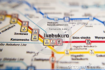 Ikebukuro Tokyo metro station on a printed paris metro map under a magnifier lens Stock Photo