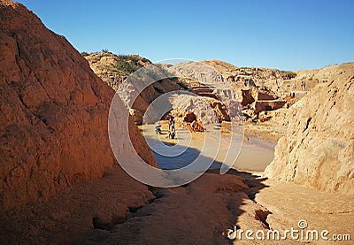 Ilakaka, Madagascar - April 30, 2019: Group of unknown Malagasy men mining sapphire in surface lake mine with shovels on a sunny Editorial Stock Photo