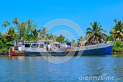 Old rusty boats on a shore of tropical sea. Cargo boat in water of island Ile-Sainte-Marie, Madagascar. Editorial Stock Photo