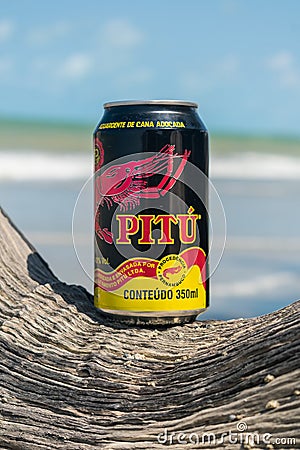A Pitu can at the beach - Pitu is an alcoholic beverage popular in Brazil Editorial Stock Photo