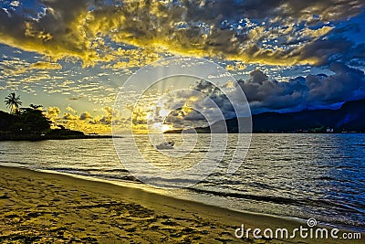 Ilhabela beach Pereque with boat in the sea at sunset - Sao Paulo, Brazil - wide angle photo Stock Photo