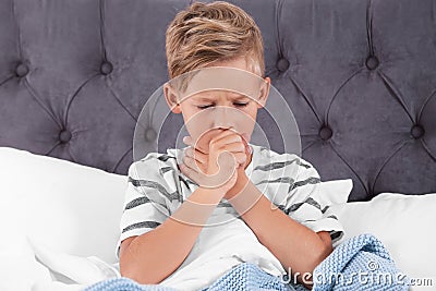 Ill boy suffering from cough in bed Stock Photo