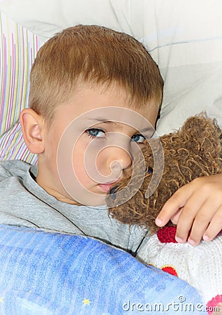 Ill boy with teddy bear Stock Photo