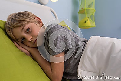 Ill child lying in hospital bed Stock Photo