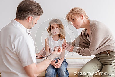 Ill child with pneumonia symptoms and professional doctor in the hospital Stock Photo