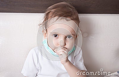 Ill little girl suffering from cough in bed at home Stock Photo