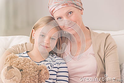 Ill woman embracing child Stock Photo