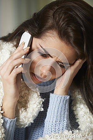 Ill Woman Phoning In Sick To Work On Mobile Phone Stock Photo