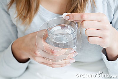 Ill woman taking aspirin Stock Photo