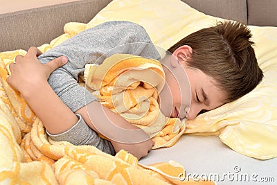 Ill young boy lying in bed 6198 Stock Photo