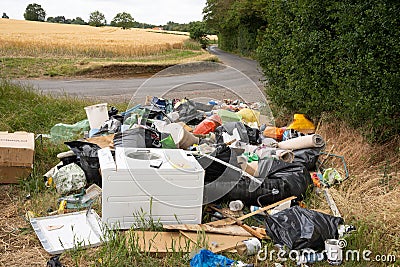 Fly tipping of household waste in a country lane. Hertfordshire. UK Editorial Stock Photo