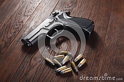 illegal handgun on wooden table Stock Photo