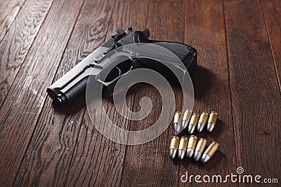 illegal handgun on wooden table Stock Photo