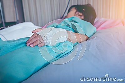 Illness asian child admitted in hospital with saline intravenous Stock Photo