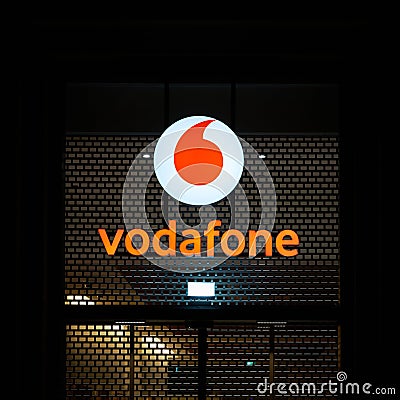 Illuminated advertisement of the mobile phone provider Vodafone in Berlin in the evening Editorial Stock Photo