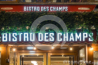 Illuminated Bistro des champs restaurant brand name on Champs Elysees avenue in Paris Editorial Stock Photo