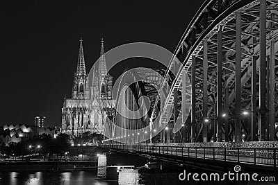 Illuminated bridge in Cologne at night in black and white Stock Photo