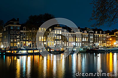 Illuminated Canals and Riverside Delights: Exploring Amsterdam After Dark Stock Photo