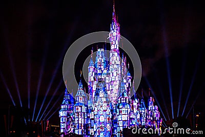 Illuminated and colorful Cinderella Castle in One Upon a Time Show at Magic Kingdom 1 Editorial Stock Photo