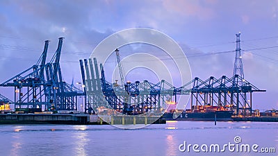 Illuminated container terminal at twilight, Port of Antwerp Editorial Stock Photo